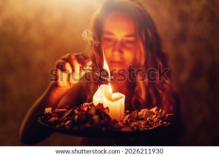 incense in a woman hand, incense smoke on a black background. Foto stock © 