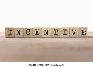 Incentive Word Written In Wooden Cube