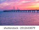 Incheon Bridge sunset view with traffic and piers by the sea at Songdo-dong, Yeonsugi-gu, beautiful golden sky, Incheon, South Korea