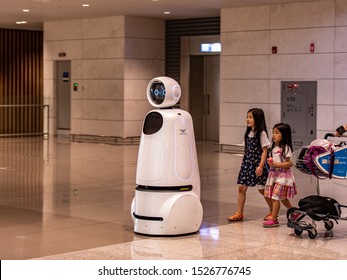 Incheon \ South Korea - 14 September 2019: Two little girl follow AIRSTAR - a passenger aiding robot at Incheon International Airport