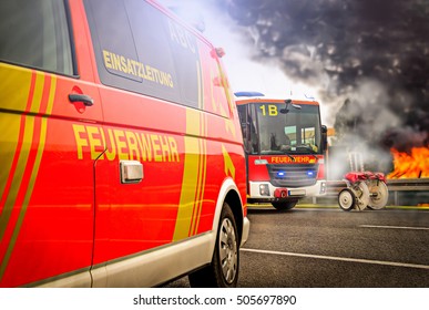 Incident Command Vehicle ( Einsatzleitung) From German (Feuerwehr) Fire Brigade Stands On A Street Near A Fire