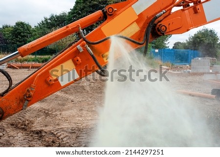 An incident in construction as a hydraulic hose on excavator split and liquid started sprinkling around under high pressure