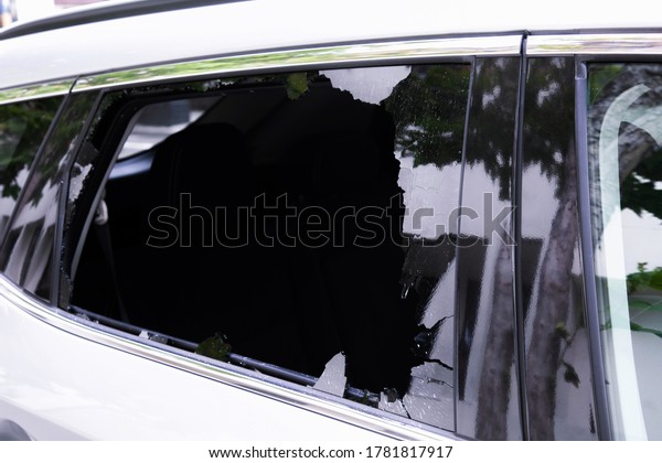 Сriminal incident. Hacking the car. Broken\
window of a car. Broken car\'s window. Concept of vandalism, crime\
and theft of personal stuff from the\
car.