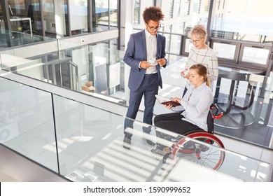 Inclusion and diversity in the business office with a businesswoman in a wheelchair