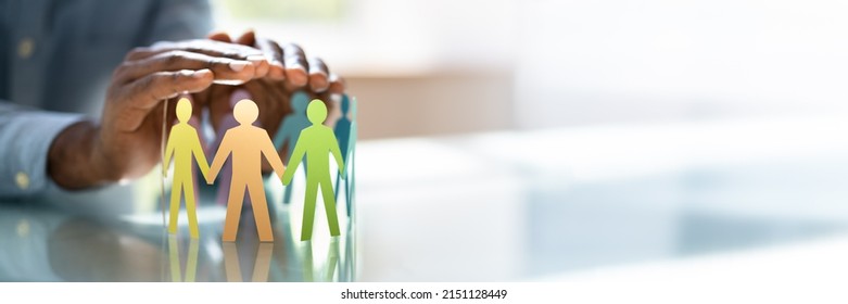 Inclusion, Diversity And Equality. African Hands Safeguard Wooden pawns - Shutterstock ID 2151128449