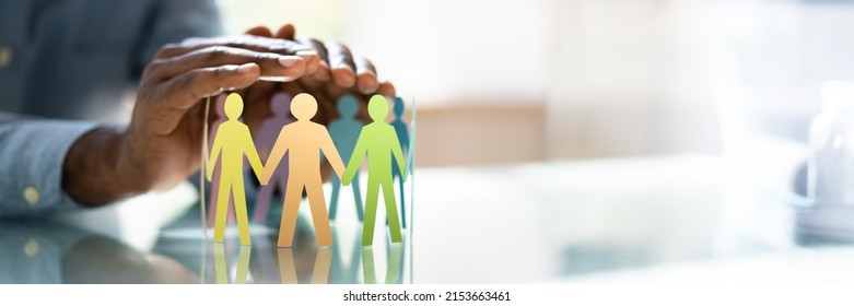 Inclusion, Diversity And Equality. African Hands Safeguard Wooden pawns - Shutterstock ID 2153663461