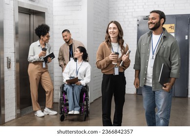 inclusion and diversity, multiethnic creative team standing together neat office elevators in hall - Powered by Shutterstock