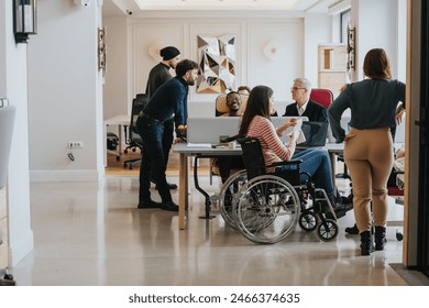 Inclusive business team in a modern office setting engaging in a collaborative discussion. - Powered by Shutterstock