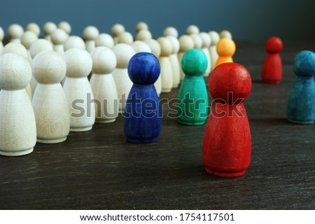 Inclusive and discrimination concept. Lines of wooden figurines and different ones as symbol of diversity.