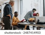 An inclusive modern office environment with a diverse team collaborating. A person in a wheelchair actively engages with colleagues.