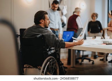 Inclusive workplace environment with diverse team engaging in business projects. - Powered by Shutterstock