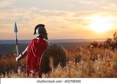 Incognito Warrior In Iron Helmet And Red Cloak.