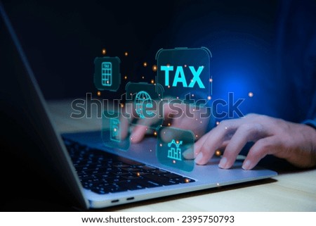 income tax. Businessman using laptop analysis tax data on futuristic virtual screen. income tax system icon around. pay online tax. futuristic virtual screen interface technology.Money saving idea