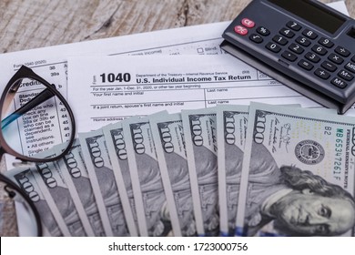 Income tax with instruction, money, calculator and glasses. Tax payment and filing concept