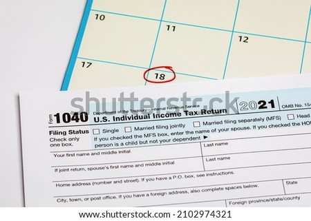 Income tax return form and calendar with filing deadline date. April 18 tax due date, financial information