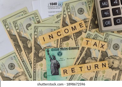 Income Tax Return US Tax Form 1040 On Dollar Bill Desk, With Calculator Stimulus Economic Tax Return Check