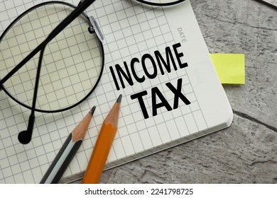 Income Tax text on notebook near pencils. - Shutterstock ID 2241798725