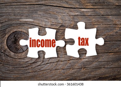 Income Tax - words on puzzle. Business conceptual