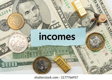 incomes.The word is written on a slip of paper,on colored background. professional terms of finance, business words, economic phrases. concept of economy.