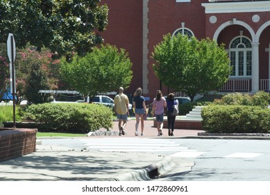 An Incoming Freshman And Her Family Tour A College Campus.