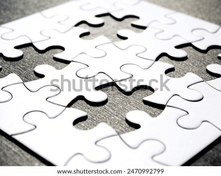 Incomplete jigsaw puzzle with four missing pieces on a black background, symbolizing incompleteness, imperfection, mistery or loss