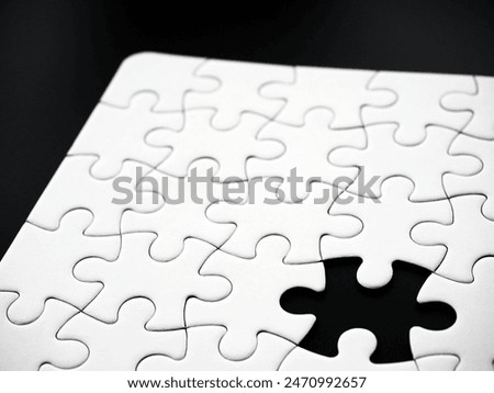 Incomplete jigsaw puzzle with one missing piece on a black background, symbolizing incompleteness, imperfection, mistery or loss