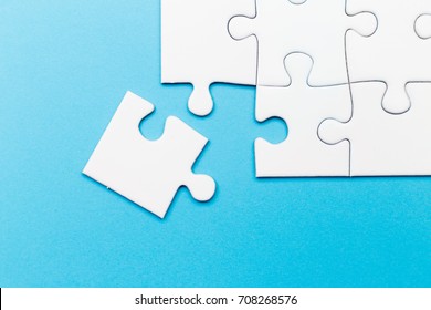 Incomplete jigsaw puzzle piece with blue background, business concept for completing the final puzzle piece. Copy space concept