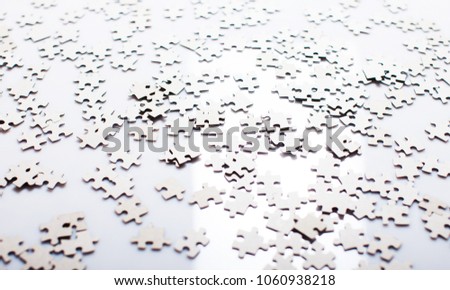 Incomplete puzzles. jigsaw puzzle. A lot of puzzles. White puzzles. White background. Texture of puzzles. Copy space