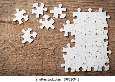 Incomplete puzzles on wooden table