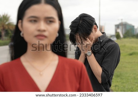 A inconsolable young man cries after being dumped by his now ex-girlfriend walking away.