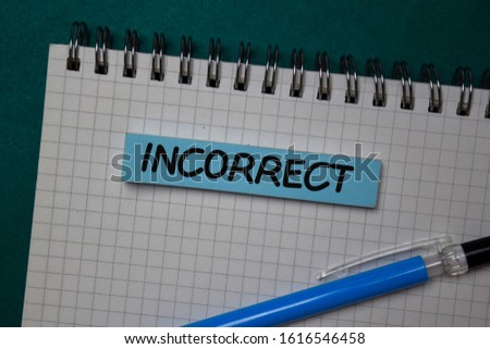 Incorrect write on a note isolated on green background.