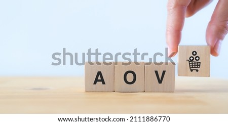 Increase average order value (AOV) concept. Strategy to get more money per oder. Order minimum, free shipping, bundle, upsell, cross sell, crm. Hand put wooden cubes with increase sales per order icon