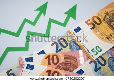 Increase in the average value of the Euro exchange rate. Euro money and green graph arrows.
