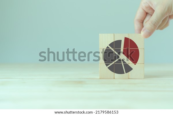 Increase market share, growth of business\
profit concept. Market penetration and expansion strategies. Wooden\
cubes showing a market share percentage using a pie chart.\
Strengthen business\
strategies.