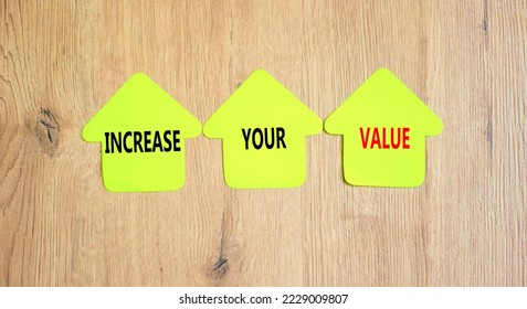 Increase your value symbol. Concept words Increase your value on green paper house on a beautiful wooden table wooden background. Business increase your value concept. Copy space.