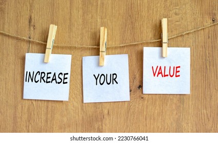 Increase your value symbol. Concept words Increase your value on white paper on a beautiful wooden table wooden background. Business increase your value concept. Copy space.