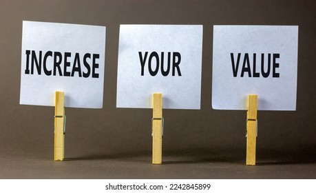 Increase your value symbol. Concept words Increase your value on white paper on a beautiful grey table grey background. Business increase your value concept. Copy space.