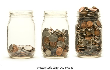 Increasing numbers of American coins in a three glass jars against a white background