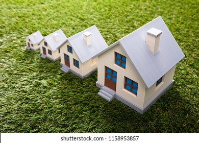 Increasing Size Of Houses On Green Grass