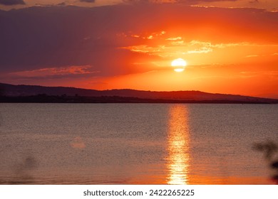 Incredible amazing, colorful summer sunsrise in Bulgaria Black coast. Orange sunset sky and reflection in the blue water. High quality photo