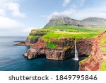 Incredible autumn view of Mulafossur waterfall in Gasadalur village, Vagar Island of the Faroe Islands, Denmark. Landscape photography