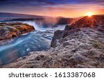 Incredible frosty morning and sunrise at the most famous place of Golden Ring Of Iceland. Godafoss waterfall near Akureyri in the Icelandic highlands, Europe. Popular tourist attraction. Postcard.