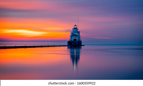 Incredible Great Lakes lighthouse on a calm morning sunrise