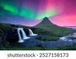 Incredible icelandic landscape with Kirkjufellsfoss waterfall under incredible sky with Northern lights. Kirkjufell volkano mountain and Polar lights in Iceland. Aurora borealis