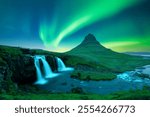 Incredible icelandic landscape with incredible sky with Northern lights over Kirkjufellsfoss waterfall. Kirkjufell volkano mountain and Polar lights in Iceland. Aurora borealis