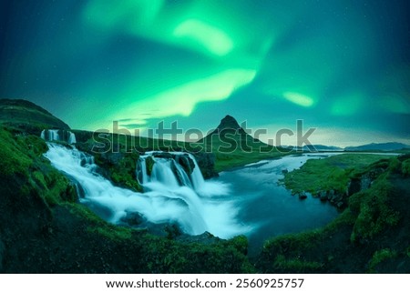 Incredible icelandic landscape with incredible sky with Northern lights over Kirkjufellsfoss waterfall. Kirkjufell volkano mountain and Polar lights in Iceland. Aurora borealis