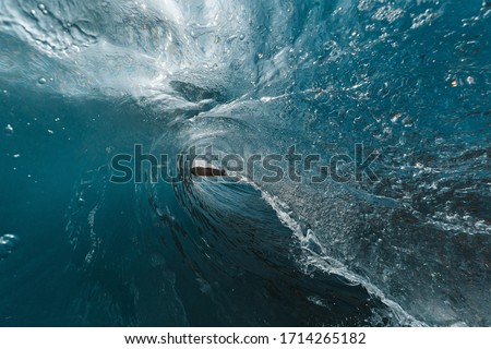 Incredible inside view of the wave. The perfect blue wave for surfing without people. one of the most beautiful waves on the planet. the wave is smooth as a mirror. fisheye photo from the water.