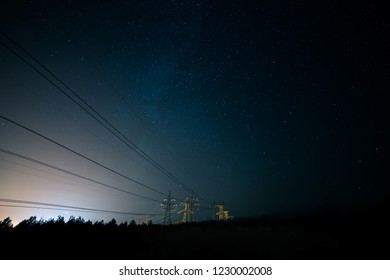 Incredible Night Sky With Stars, Milky Way Passing Over Power Line In Long Exposure Timelapse. Beautiful Panorama View. Nature In The Countryside. Astro Photography