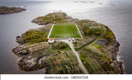 Incredible soccerfield sorrounded by water sea and mountains, Henningsvaer, Lofoten Islands, Norway 2020