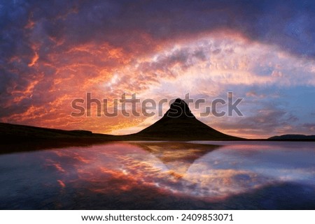 Incredible sunset over Kirkjufell mountain reflected in the clear waters of a mountain lake in Iceland. Landscape photography